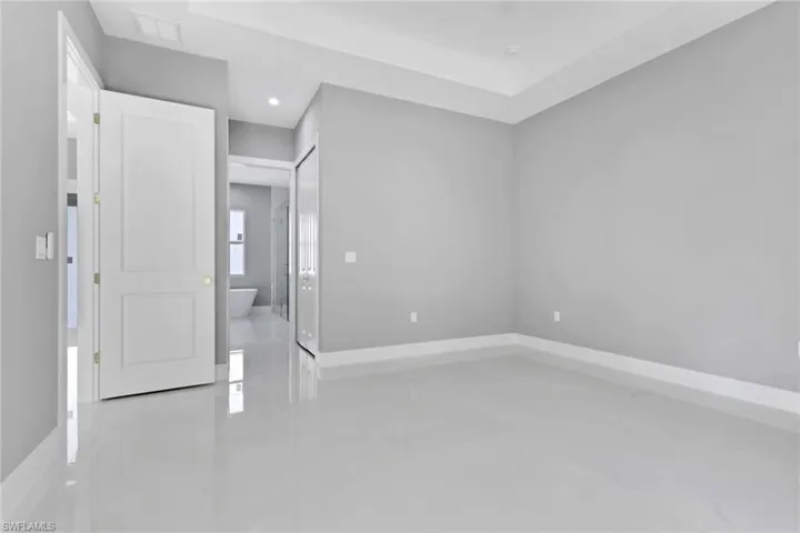 Spare room with baseboards and recessed lighting