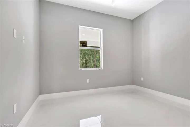 Empty room featuring light tile patterned floors