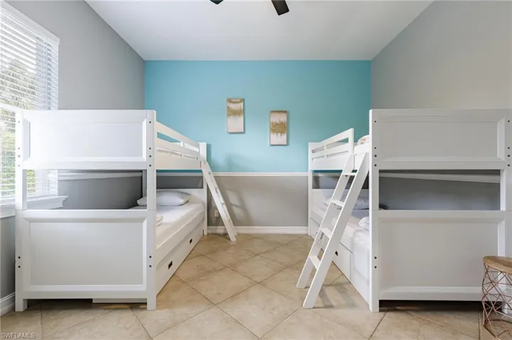 Bedroom featuring a ceiling fan and light tile patterned floors