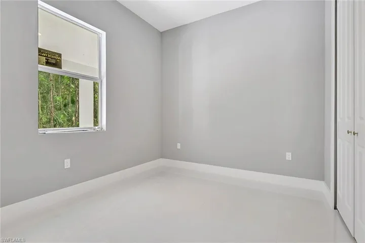 Empty room featuring baseboards