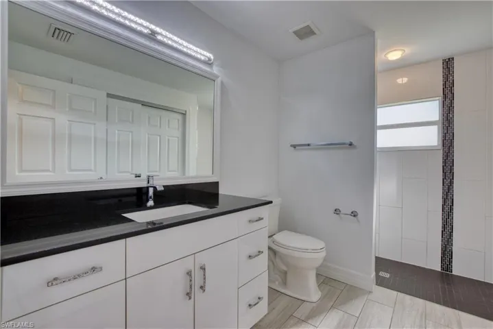 Full bath featuring vanity and a walk in shower