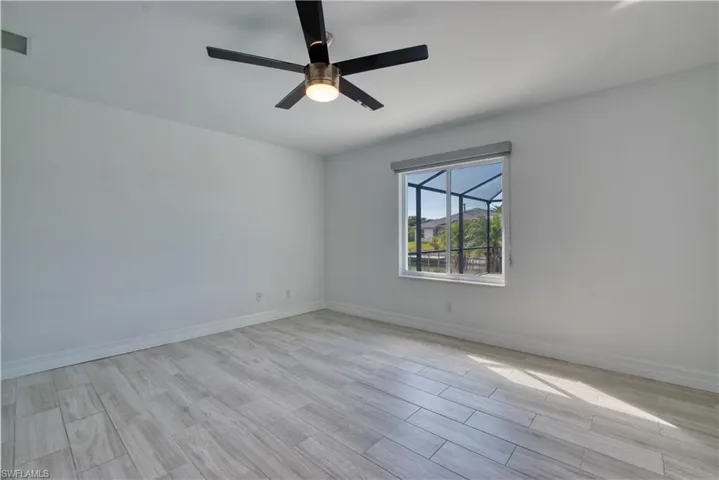 Empty room with wood tiled floors and ceiling fan