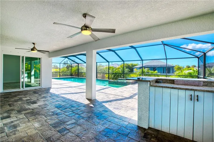 Integrated pool / spa featuring a patio area, a sunroom, and glass enclosure