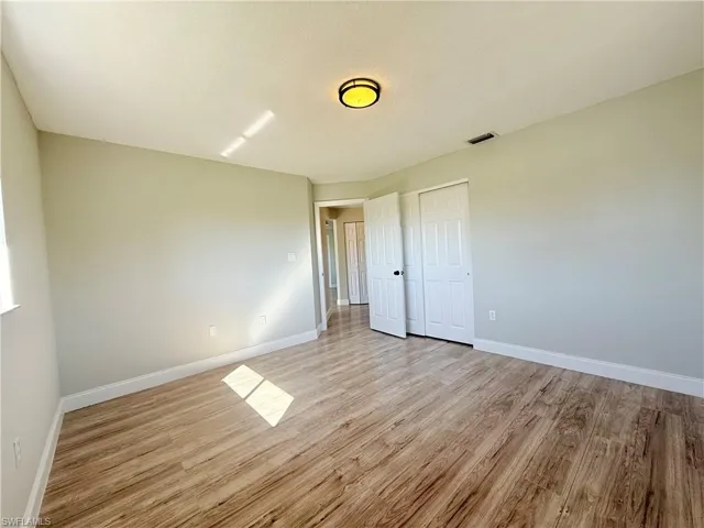 Unfurnished room with light wood-style flooring and baseboards