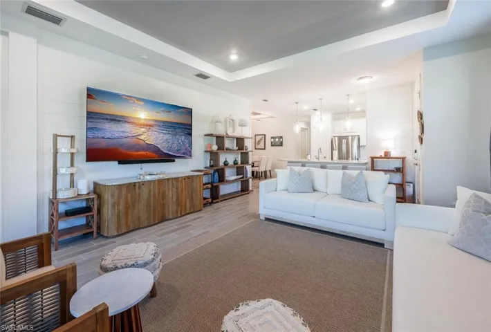Living room with a raised ceiling and sink
