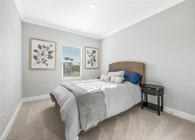 Carpeted bedroom featuring ornamental molding