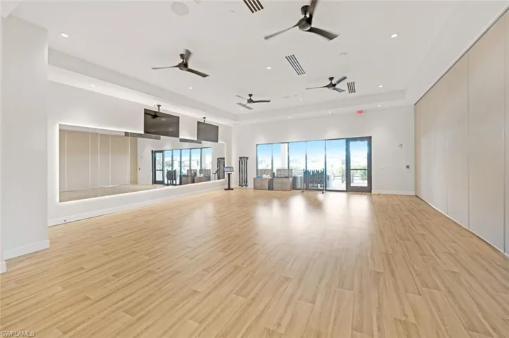 Unfurnished living room featuring a towering ceiling and light wood-type flooring