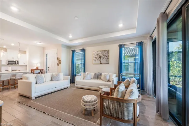 Living room with plenty of natural light and a tray ceiling