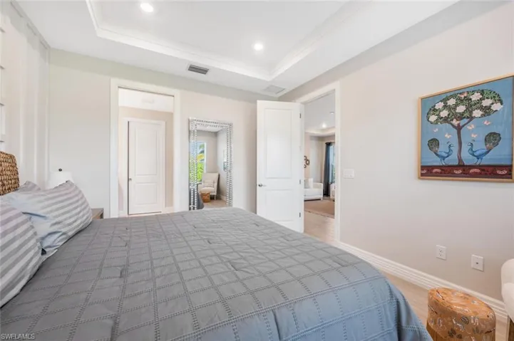 Bedroom featuring crown molding and a raised ceiling