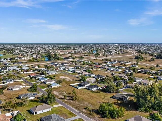 Aerial overview of property's location featuring nearby suburban area and a nearby body of water