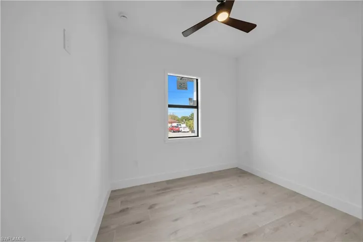 Empty room featuring light wood-style floors and a ceiling fan
