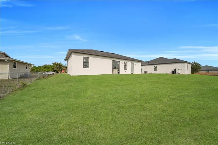 Back of property featuring stucco siding