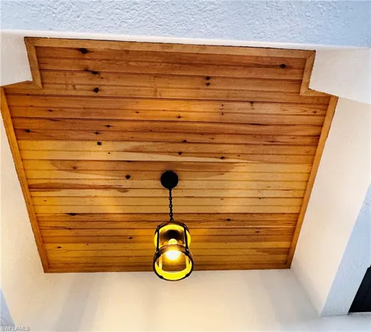 Detailed view of a textured wall and wooden ceiling