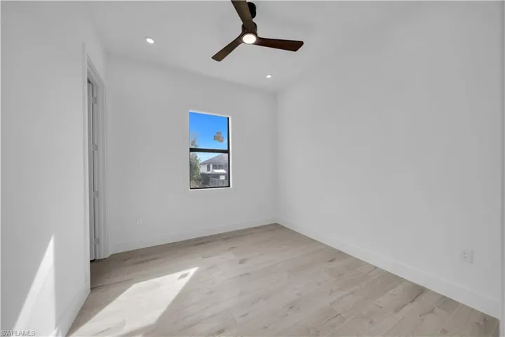 Unfurnished room featuring light wood-type flooring, ceiling fan, and recessed lighting