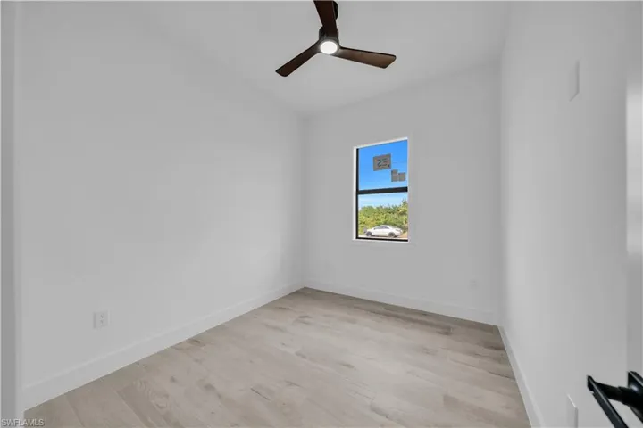 Spare room with light wood-type flooring and a ceiling fan