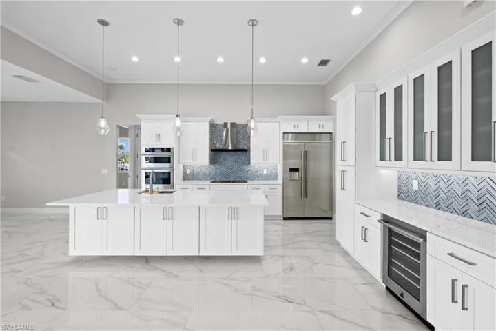 Bar and kitchen with island and cabinets