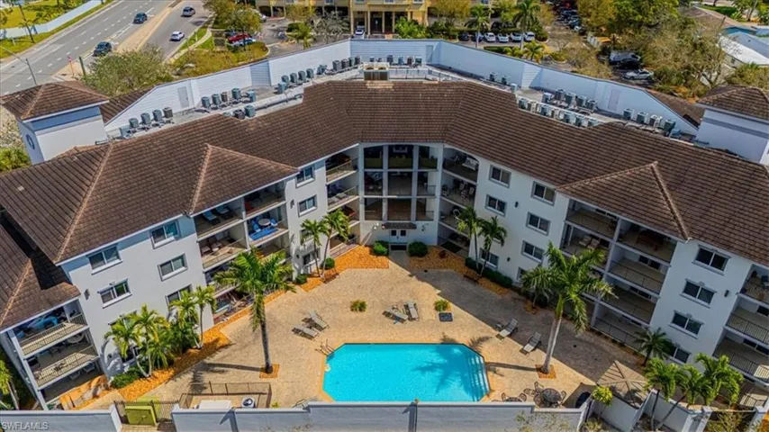 Drone / aerial view of a pool and apartment complex