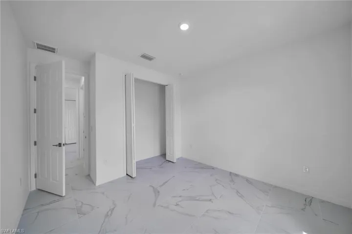 GUEST Spacious interior room featuring light-toned flooring with a marble-effect pattern