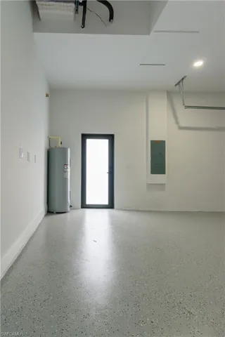 Garage with water heater and electric panel