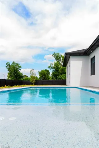 View of swimming pool with a fenced in pool and fence