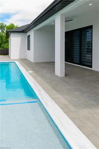 View of swimming pool featuring a fenced in pool and a patio
