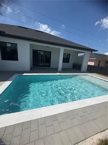 View of pool with fence, a fenced in pool, and a patio area