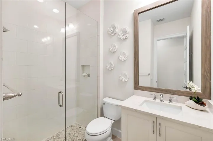 Full bathroom with vanity and a stall shower
