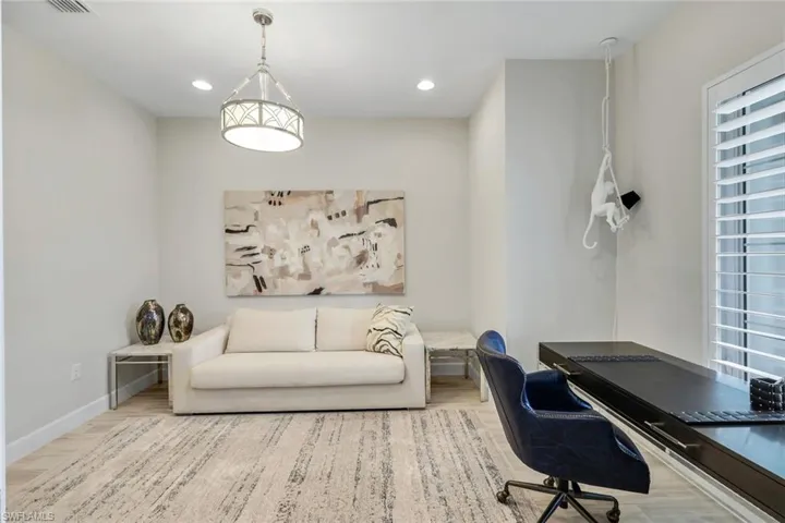 Office space featuring light wood finished floors and recessed lighting