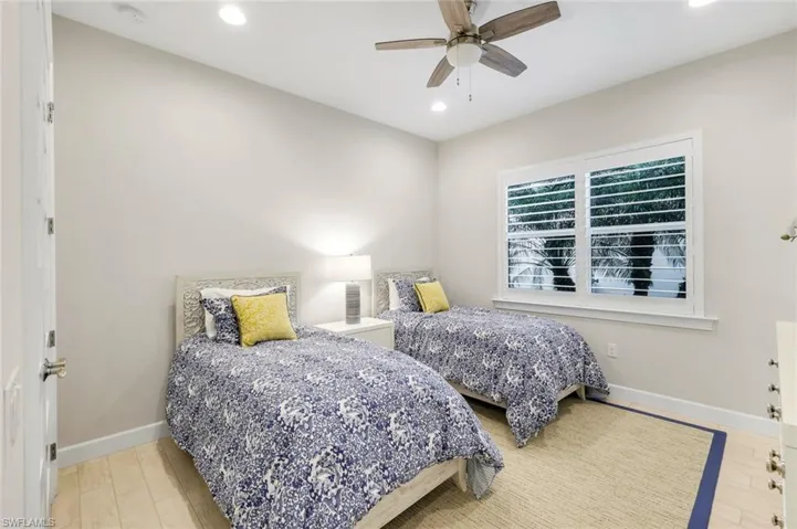 Bedroom with ceiling fan, recessed lighting, and light wood finished floors