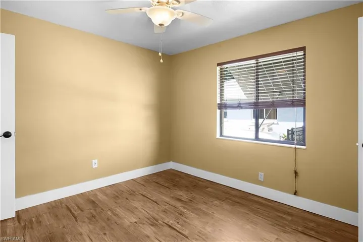 Unfurnished room featuring light wood-type flooring and a ceiling fan