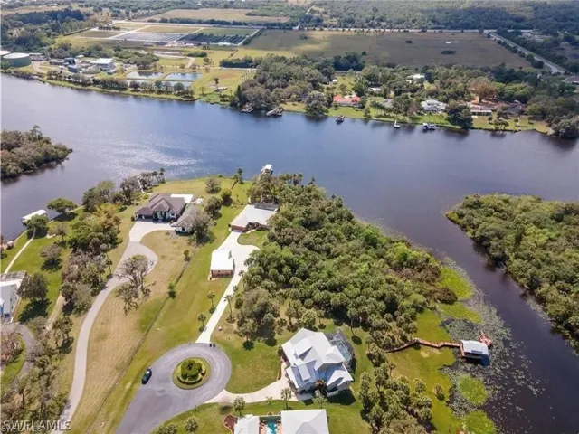 Aerial view of property's location with a large body of water