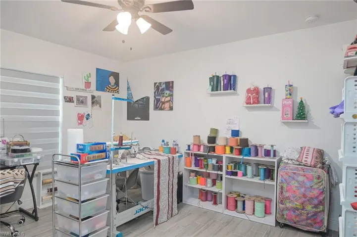 Playroom featuring light wood-type flooring and ceiling fan