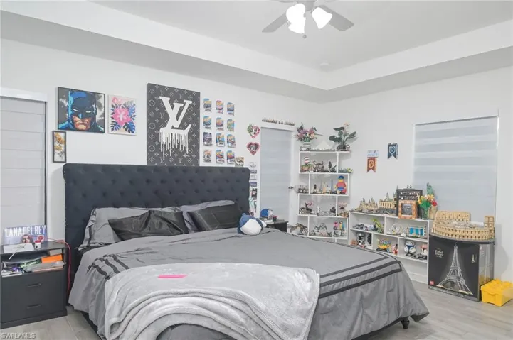 Bedroom featuring ceiling fan and hardwood / wood-style flooring
