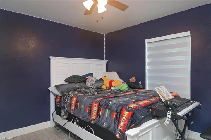 Bedroom featuring hardwood / wood-style floors and ceiling fan