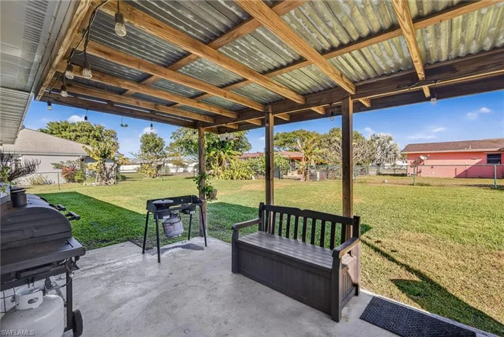 Fenced backyard with a patio and grilling area
