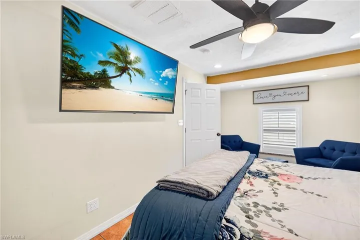 Bedroom with a ceiling fan and recessed lighting