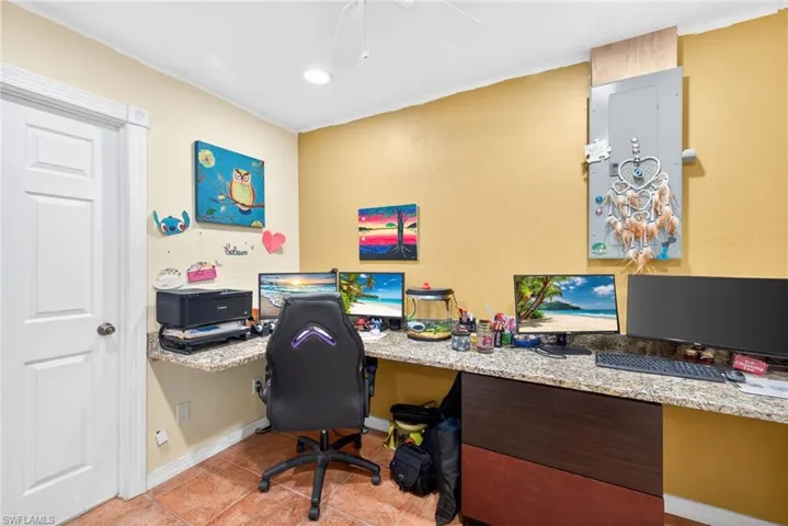 Office space featuring built in study area, light tile patterned flooring, a ceiling fan, and recessed lighting