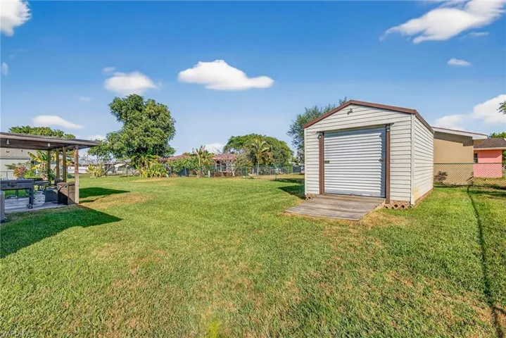 View of yard with an outbuilding and a patio area