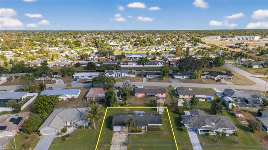 Aerial view of residential area with property boundaries highlighted