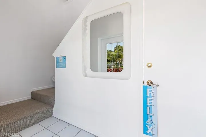 Entrance foyer of the unit with interior stairs up to the unit.