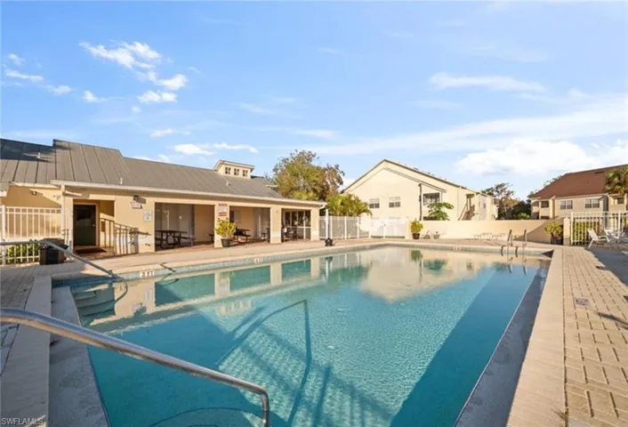 Community pool featuring a patio area and a residential view