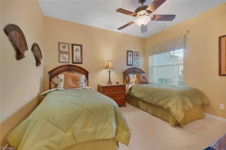 Bedroom with ceiling fan and carpet floors