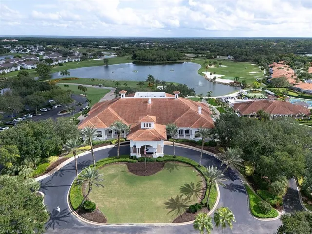 Aerial view of residential area with a large body of water and a golf club