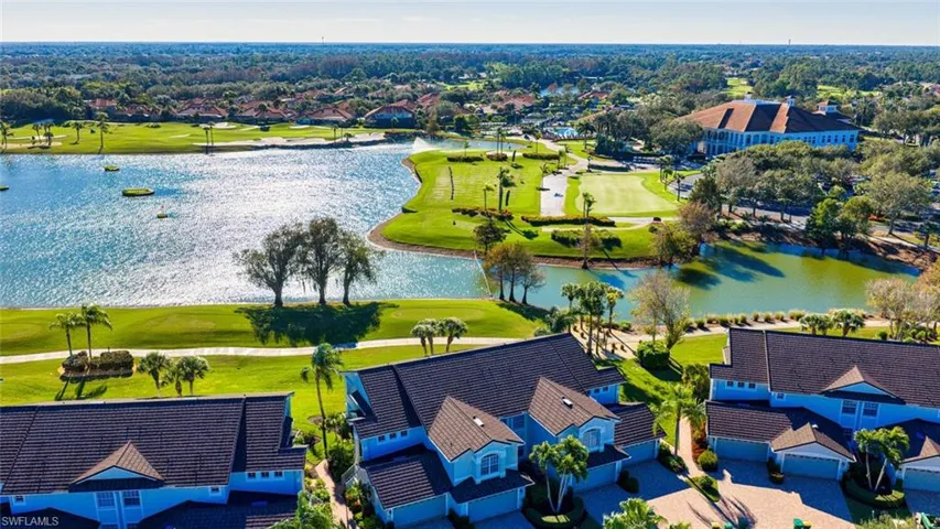 Aerial perspective of suburban area featuring a nearby body of water and a golf club