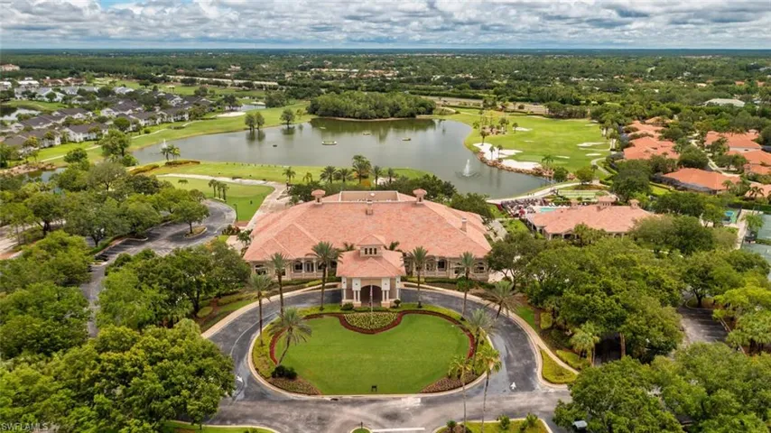 Aerial perspective of suburban area featuring a large body of water and a local golf course