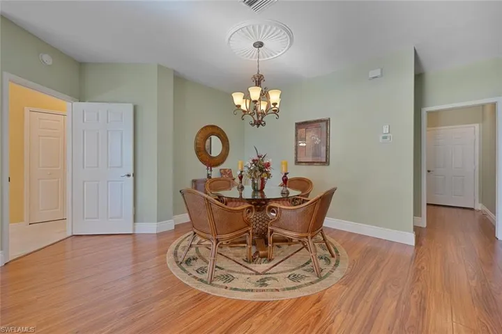 Dining space with a chandelier and light wood-style flooring