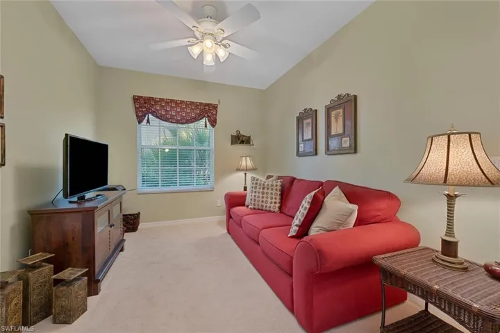 Living room with light carpet and ceiling fan