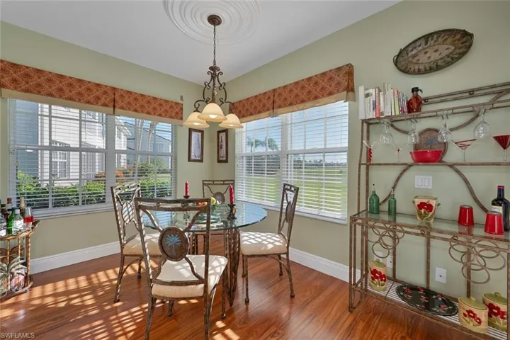 Dining room with wood finished floors and a chandelier