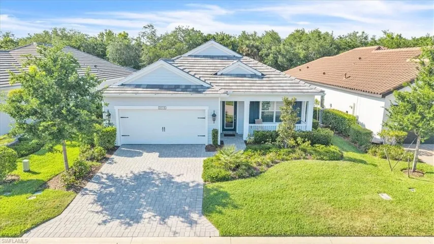 Single-story residence featuring a shingled roof, light gray siding, and a covered front porch with white railings