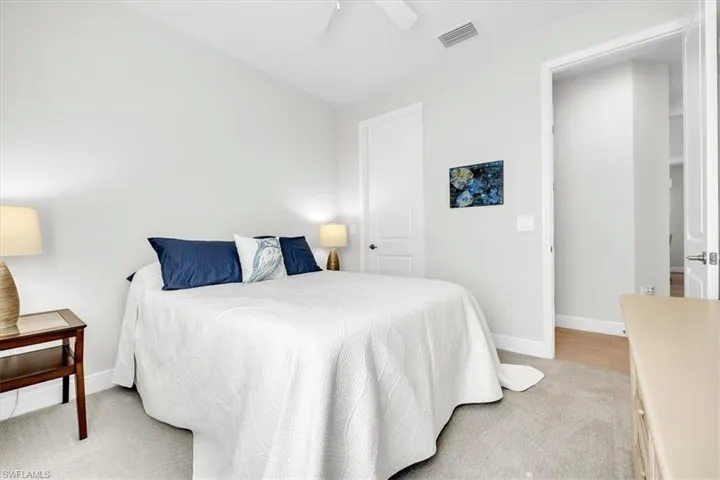 Carpeted bedroom with neutral wall tones and white trim